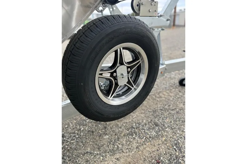 Slide: The Image of Close-up of a 2026 Thunder Jet 22 Chinook OS trailer wheel on gravel. - 50