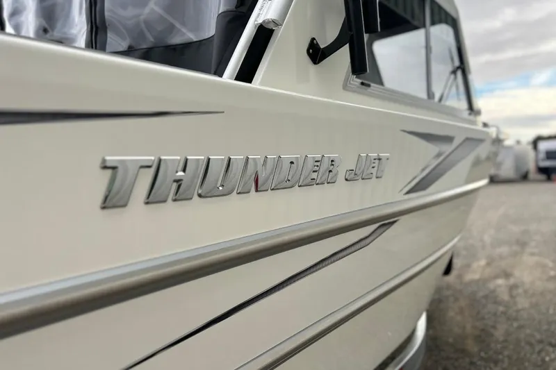 Slide: The Image of 2026 Thunder Jet 22 Chinook OS boat, side view with logo detail. - 7