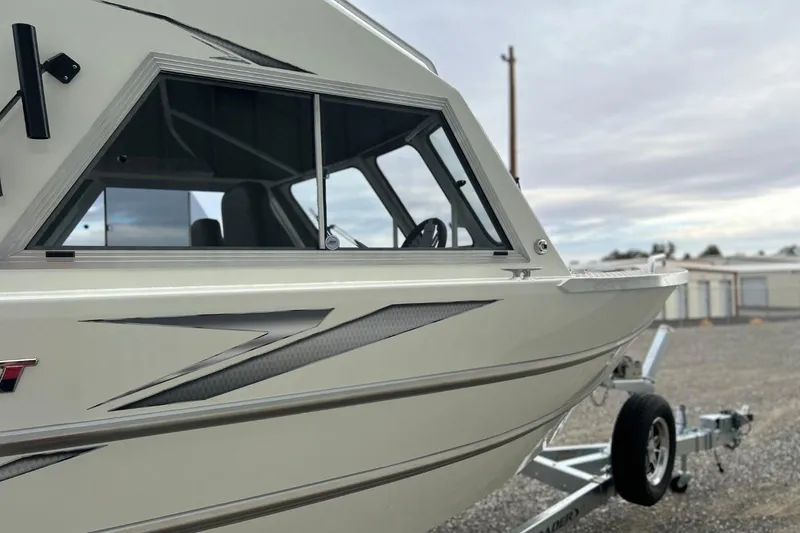 Slide: The Image of 2026 Thunder Jet 22 Chinook OS boat on trailer, side view with sleek design. - 8