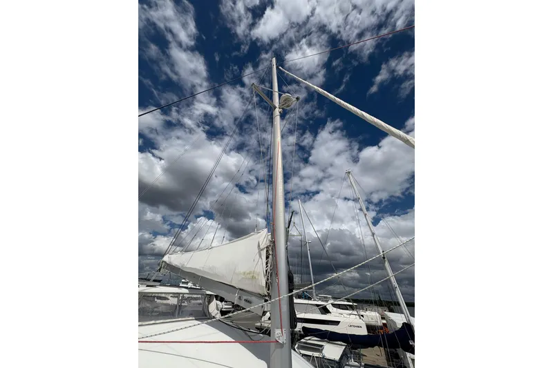 Slide: The Image of Mast and sails of a 2004 Lagoon 380 catamaran against a cloudy sky. - 16