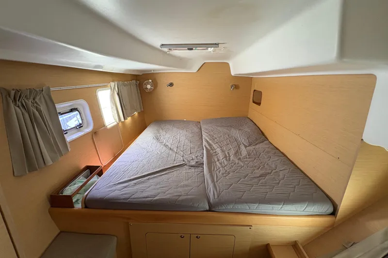 Slide: The Image of Interior cabin of a 2004 Lagoon 380 catamaran with a cozy double bed. - 20