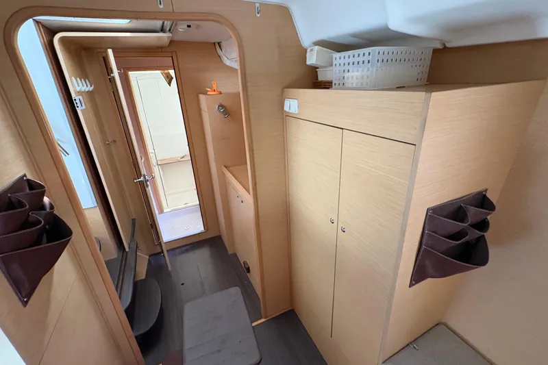 Slide: The Image of Interior of 2004 Lagoon 380 catamaran, featuring wooden cabinetry and compact design. - 21