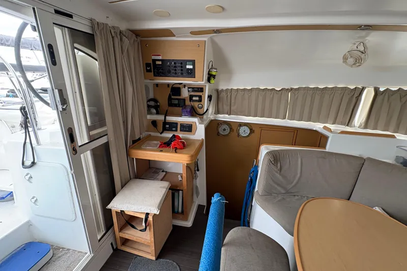 Slide: The Image of Interior of 2004 Lagoon 380 catamaran with navigation station and seating area. - 24