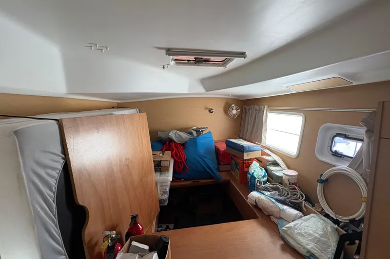 Slide: The Image of Interior of a 2004 Lagoon 380 boat cabin with storage items and equipment. - 25