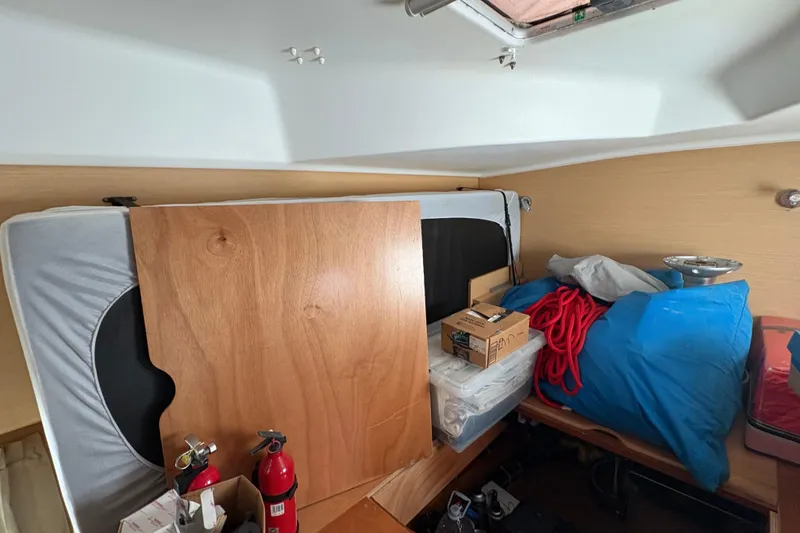 Slide: The Image of Interior of a 2004 Lagoon 380 boat with storage items and fire extinguishers. - 27
