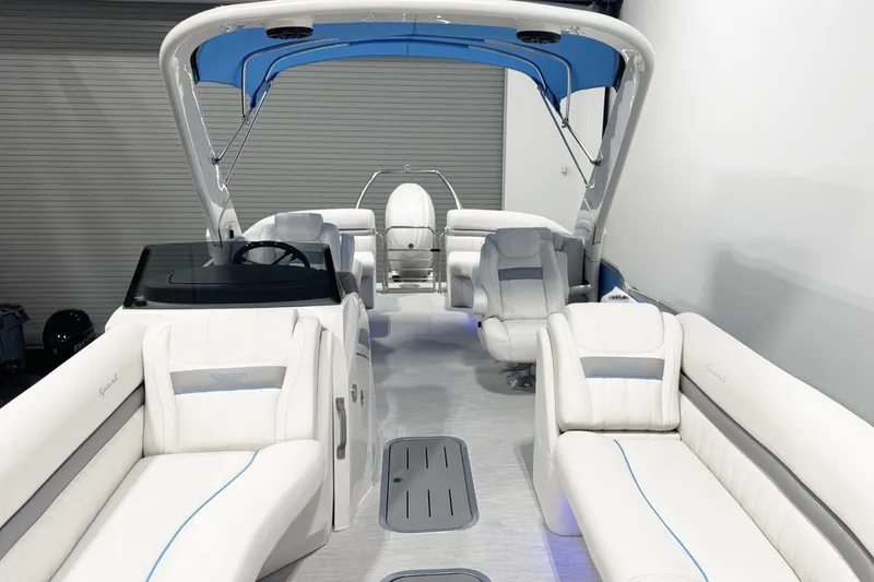 Slide: The Image of 2026 Bennington 24 LXS FASTBACK SPORT ARCH with luxurious white seating and blue canopy. - 10