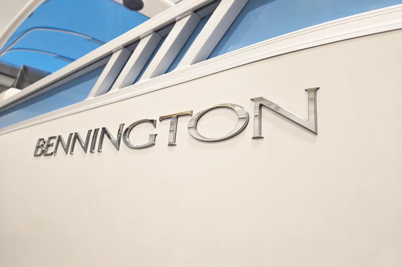 Slide: The Image of Bennington 24 LXS Fastback Sport Arch 2026 boat logo on sleek exterior. - 5
