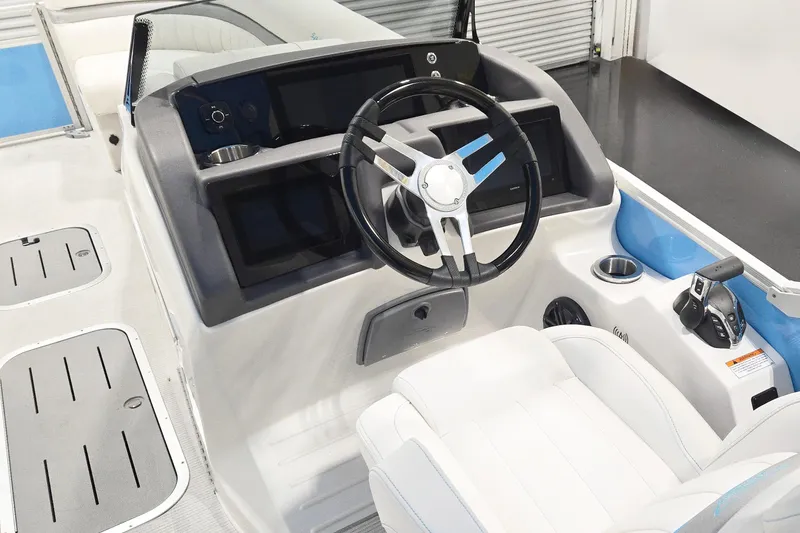 Slide: The Image of 2026 Bennington 24 LXS FASTBACK SPORT ARCH boat helm with steering wheel and controls. - 7