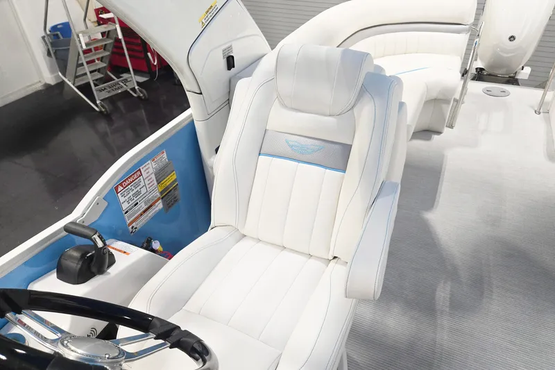 Slide: The Image of 2026 Bennington 24 LXS FASTBACK SPORT ARCH boat interior with white seating and steering wheel. - 8