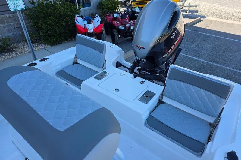 Slide: The Image of 2026 NauticStar 194 Bay boat interior with cushioned seating and outboard motor. - 10