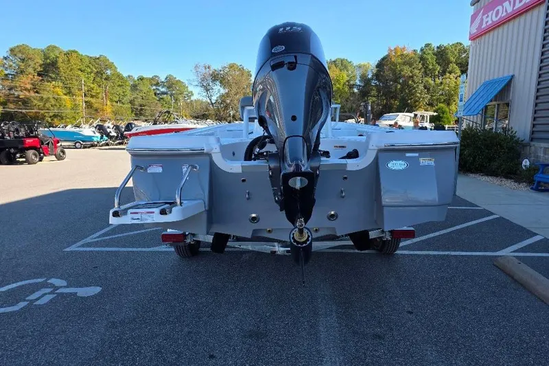Slide: The Image of 2026 NauticStar 194 Bay boat with outboard motor in a parking lot. - 3