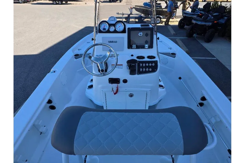 Slide: The Image of 2026 NauticStar 194 Bay boat interior with steering console and seating. - 6