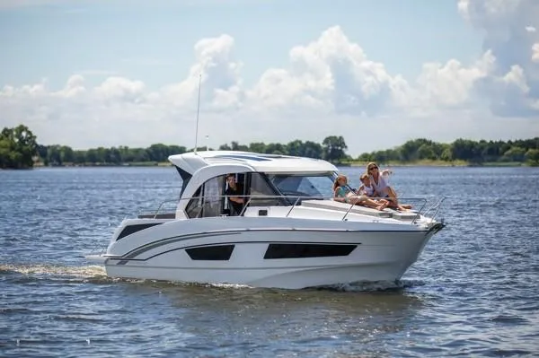 The Image of 2024 Beneteau Antares 9 cruising on a lake with passengers enjoying the sun. - 0