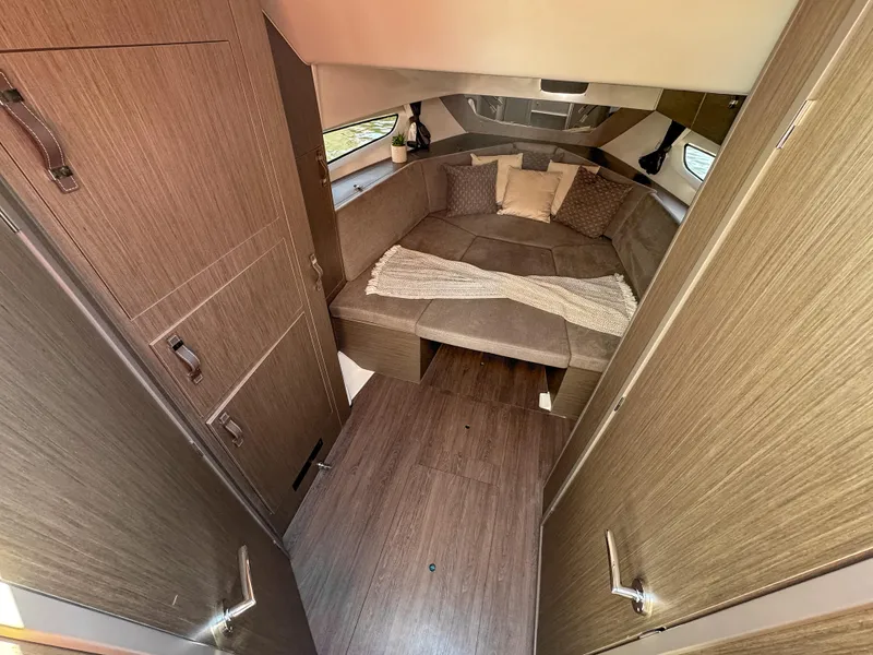 Slide: The Image of 2024 Beneteau Flyer 10 cabin interior with cozy seating and modern wood finish. - 13