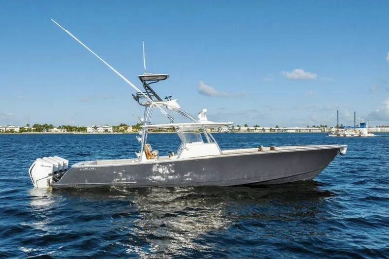 Slide: The Image of 2020 Valhalla Boatworks V-41 cruising on a sunny day, showcasing sleek design and powerful engines. - 2