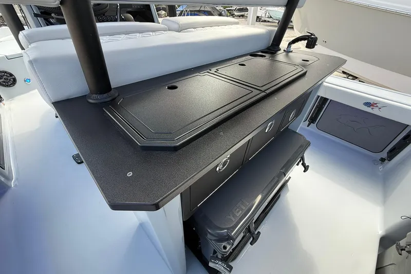 Slide: The Image of 2026 Crevalle 26 HCO boat interior with storage compartments and seating area. - 13