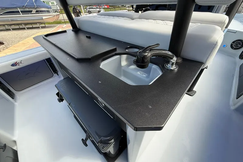 Slide: The Image of 2026 Crevalle 26 HCO boat interior with sink and seating area. - 14