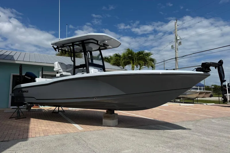 Slide: The Image of 2026 Crevalle 26 HCO boat displayed outdoors under a clear blue sky. - 2