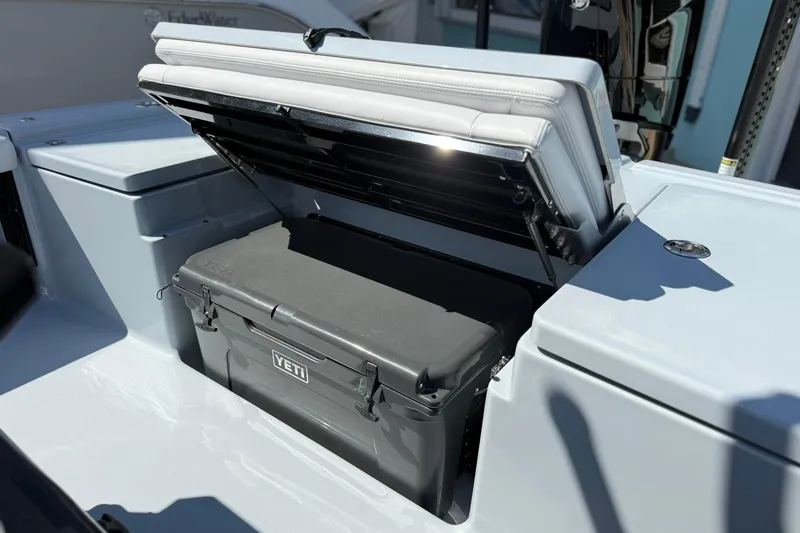 Slide: The Image of 2026 Crevalle 26 HCO boat with YETI cooler in storage compartment. - 24