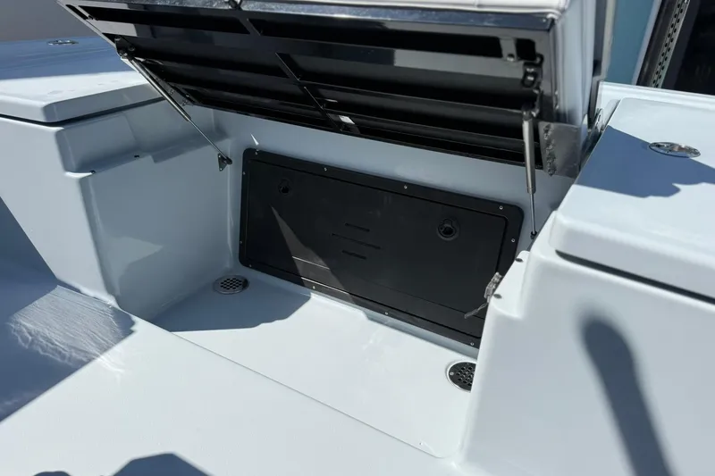 Slide: The Image of 2026 Crevalle 26 HCO boat storage compartment with open hatch, showcasing sleek design. - 25