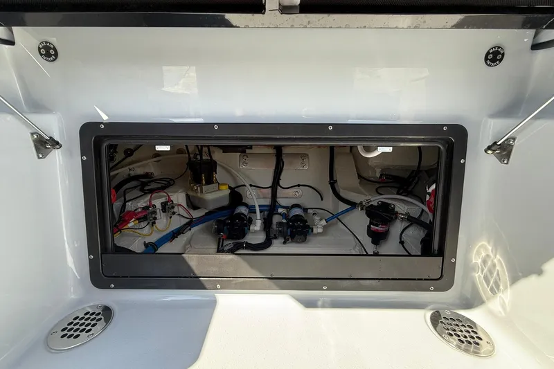 Slide: The Image of 2026 Crevalle 26 HCO boat compartment showcasing internal wiring and components. - 26