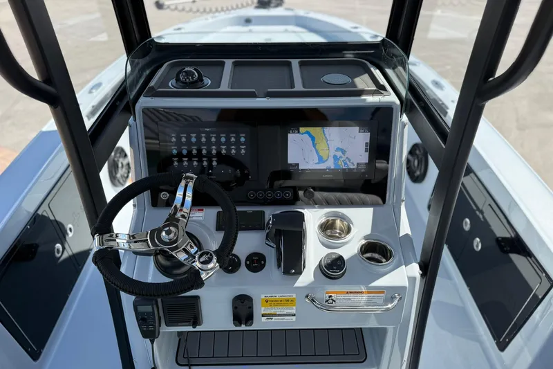 Slide: The Image of 2026 Crevalle 26 HCO boat console with steering wheel, navigation display, and controls. - 31