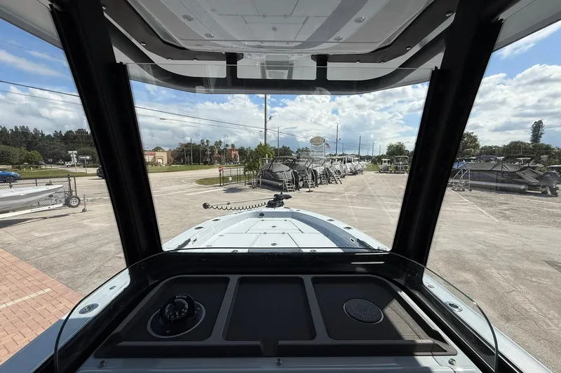 Slide: The Image of Interior view of 2026 Crevalle 26 HCO boat, showcasing dashboard and windshield. - 36