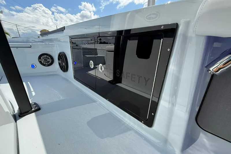 Slide: The Image of 2026 Crevalle 26 HCO boat interior with speakers and safety compartment. - 38