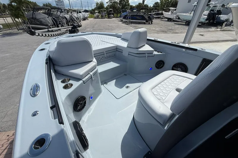 Slide: The Image of 2026 Crevalle 26 HCO boat interior with seating and speakers in a marina setting. - 39