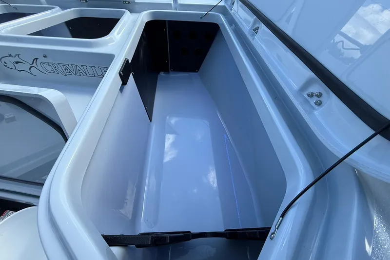 Slide: The Image of Interior storage compartment of 2026 Crevalle 26 HCO boat, featuring sleek design and ample space. - 47