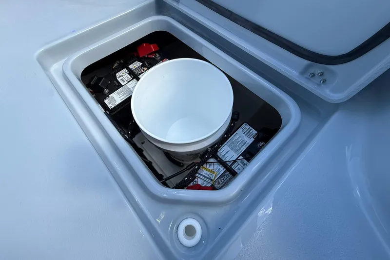Slide: The Image of Battery compartment of 2026 Crevalle 26 HCO boat with white bucket inside. - 48