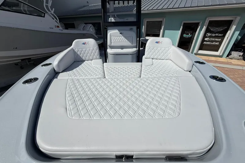 Slide: The Image of 2026 Crevalle 26 HCO boat interior with diamond-stitched white seating and modern design. - 54