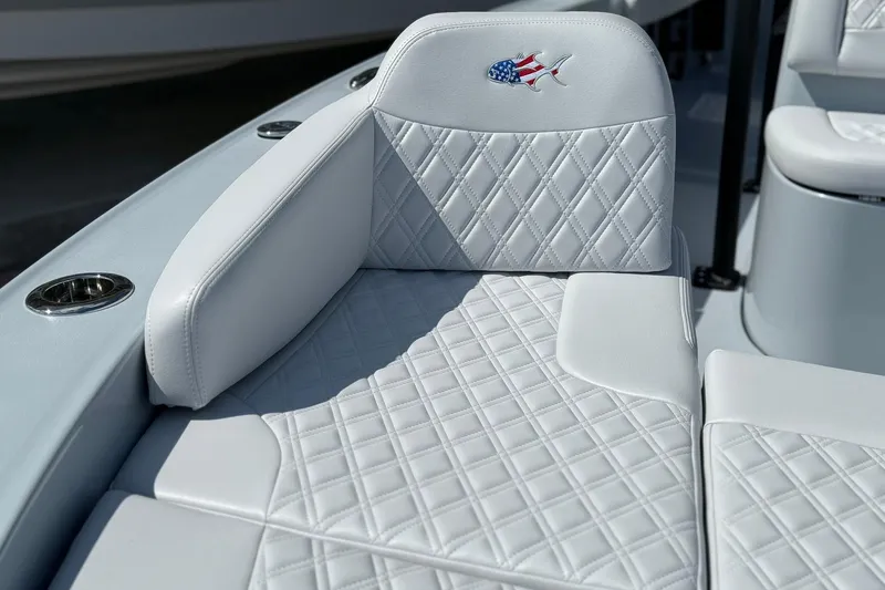Slide: The Image of 2026 Crevalle 26 HCO boat seat with diamond stitching and American flag fish logo. - 55