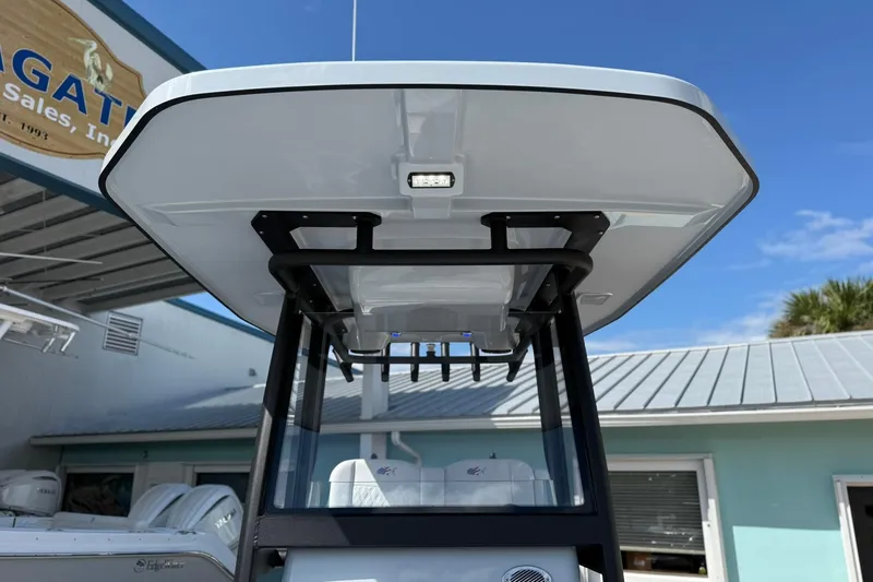 Slide: The Image of 2026 Crevalle 26 HCO boat T-top and console, outdoor dealership display. - 58