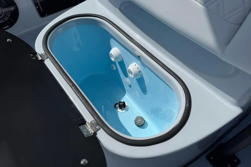 Slide: The Image of Livewell in 2026 Crevalle 26 HCO boat, featuring blue interior and white seating. - 60