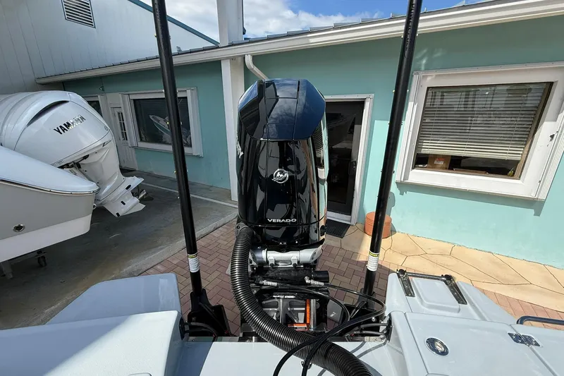 Slide: The Image of 2026 Crevalle 26 HCO boat with powerful outboard motor in a sunny marina setting. - 8