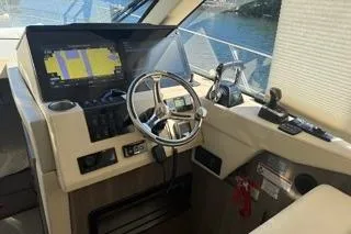 Slide: The Image of 2021 Regal 38 XO yacht helm with navigation display and steering wheel. - 13