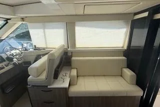 Slide: The Image of 2021 Regal 38 XO yacht interior with beige seating and modern helm. - 17