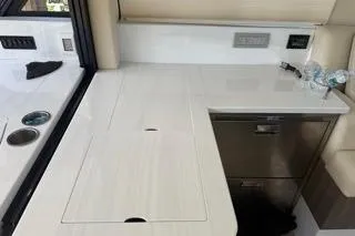 Slide: The Image of Modern bathroom sink in 2021 Regal 38 XO yacht, featuring sleek design and mirror. - 24