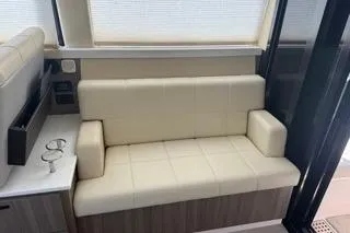 Slide: The Image of Interior of 2021 Regal 38 XO yacht with white seating and scenic window view. - 30