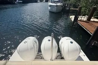 Slide: The Image of 2021 Regal 38 XO boat docked with triple outboard engines. - 36