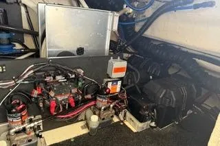 Slide: The Image of Engine room of a 2021 Regal 38 XO boat, featuring equipment and wiring. - 48