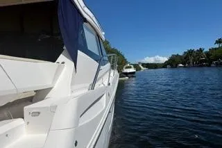 Slide: The Image of 2021 Regal 38 XO yacht docked, featuring sleek design and spacious deck. - 52