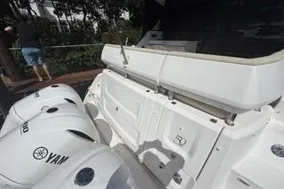 Slide: The Image of 2021 Regal 38 XO yacht cruising on a serene river under a clear blue sky. - 53