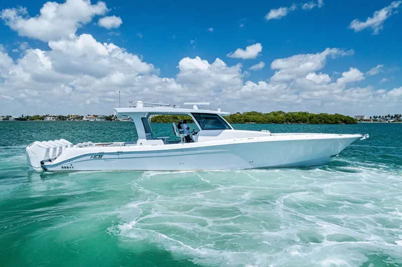 Slide: The Image of 2025 HCB 56 Suenos GIX luxury boat cruising on clear blue water. - 10
