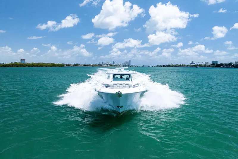 Slide: The Image of 2025 HCB 56 Suenos GIX cruising on turquoise waters under a clear blue sky. - 12