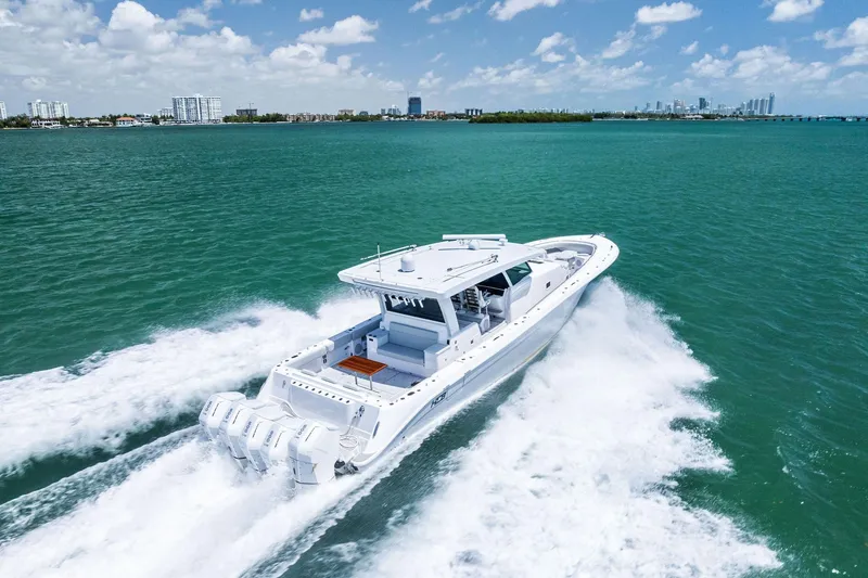 Slide: The Image of 2025 HCB 56 Suenos GIX cruising on turquoise waters under a clear sky. - 15