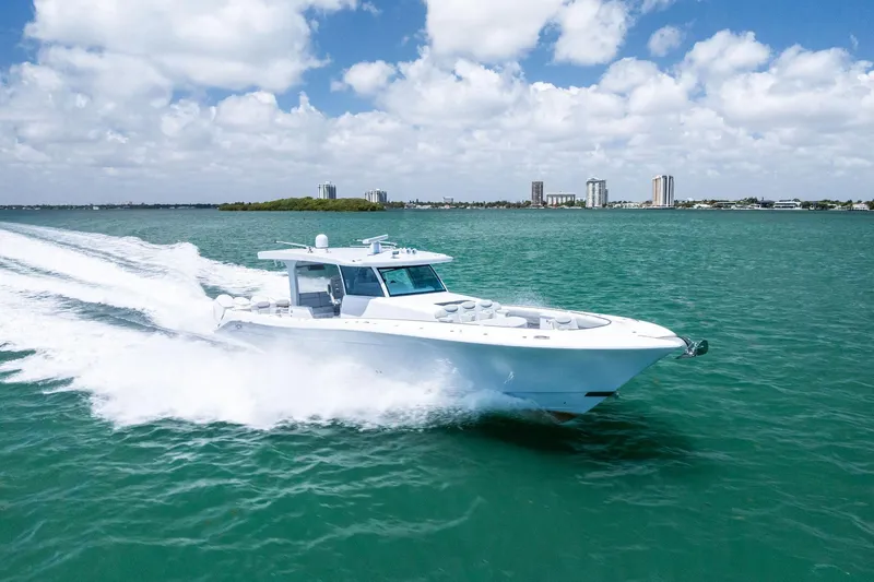 Slide: The Image of 2025 HCB 56 Suenos GIX yacht cruising on turquoise water under a partly cloudy sky. - 16