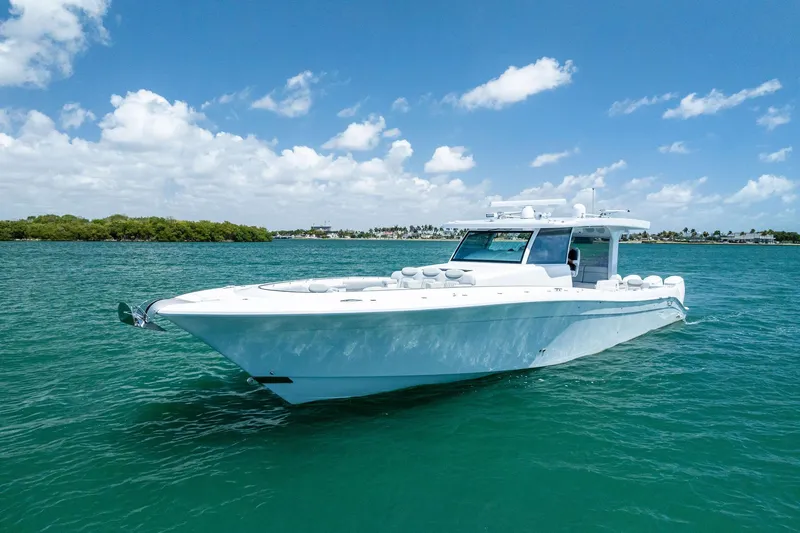 Slide: The Image of 2025 HCB 56 Suenos GIX luxury yacht cruising on clear blue waters. - 2