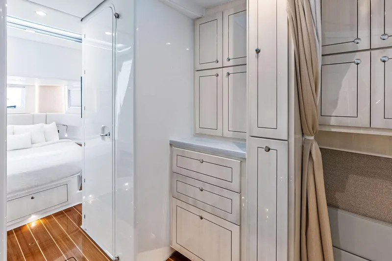 Slide: The Image of Luxurious interior of 2025 HCB 56 Suenos GIX yacht with elegant cabinetry and cozy bedroom. - 25